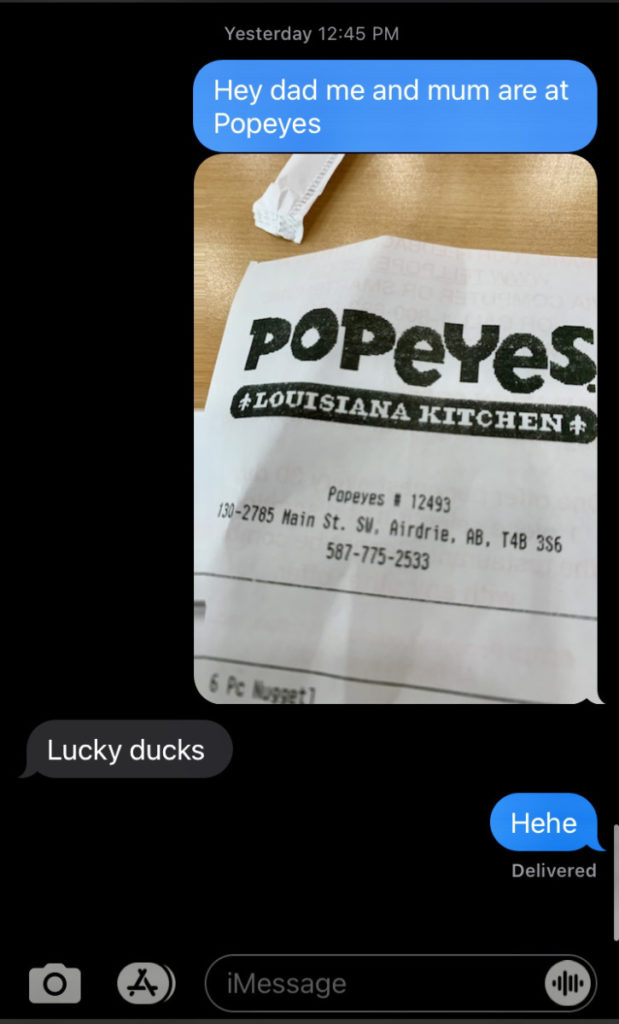 a screenshot of text messages taking about going to Popeyes chicken restaurant. 