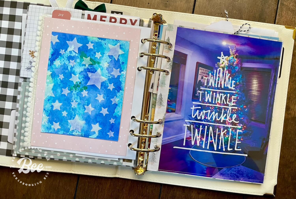 A photo of Amanda's 2020 December daily album, showing a page decorated in blue shades with stars overtop, the other page is aa photo of a Christmas tree and says Twinkle.